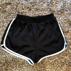 Black shorts with white trim. Shiny/silky texture